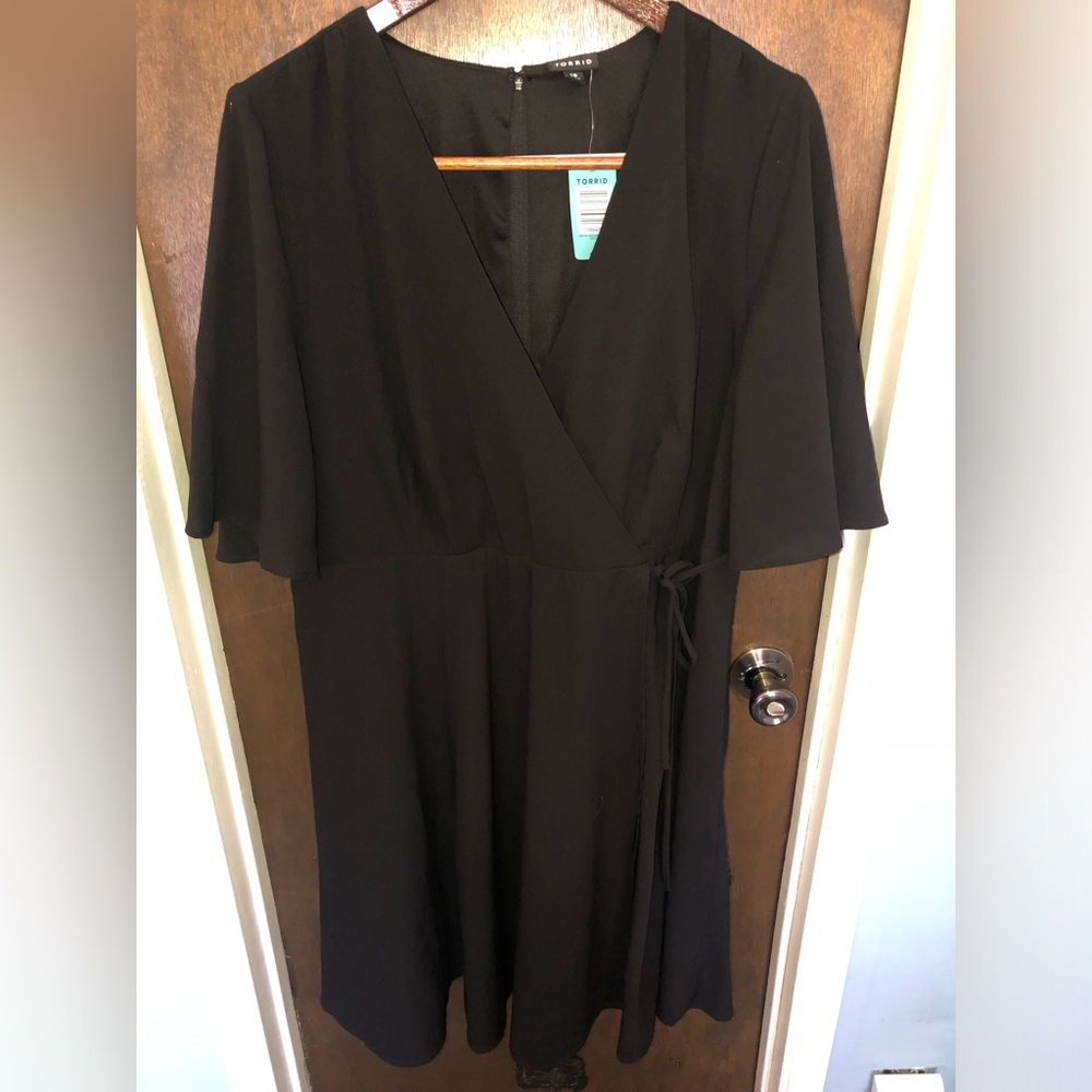 BNWT Torrid black dress. Wrap around, ties on side.